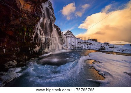 Colorful winter sunset at Kirkjufellsfoss waterfall Iceland