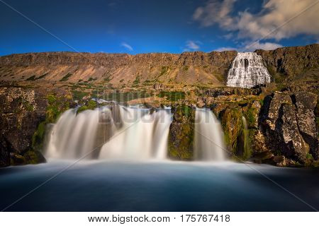 Dynjandi waterfalls and cliffs in sunny weather Iceland