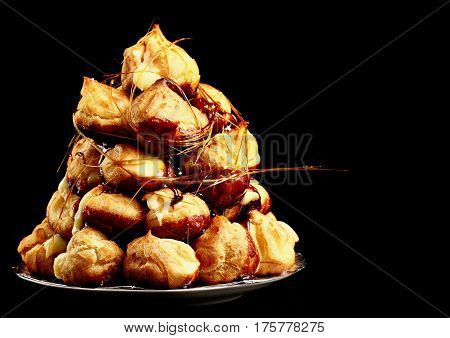 Cake Profiteroles With Caramel On Black Background.selective Focus.copy Space