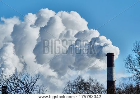 the thick smoke belching from factory chimneys