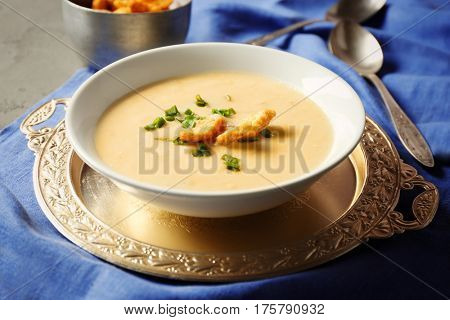 Delicious cream soup with bread on table