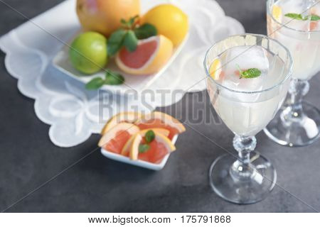 Glass with delicious wine spritzer on grey table