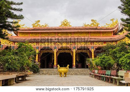Statue of Big Golden Sitting Buddha in Van Hanh pagoda monastery in Dalat, Vietnam