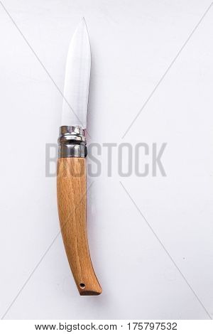 Knife with a wooden handle. Gray background.