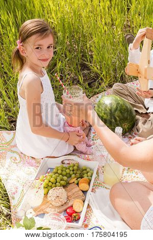 Family on summer picninc in the countryside.