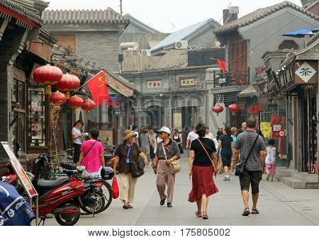 Beijing, China - Jul 4, 2011: Tourists Walking At Yandan (pipe) Hutong. This Ancient Street Is Very