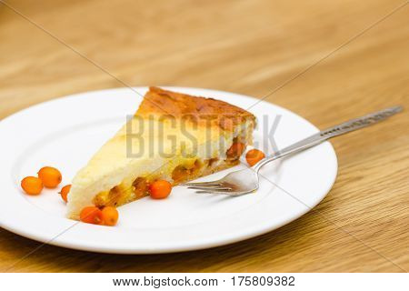 homemade cheese cake slice on a white plate with a fork