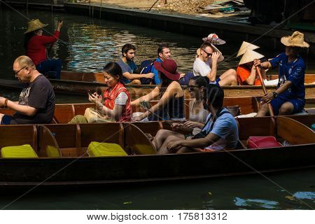 THAILAND DAMNOEN SADUAK - March 20 2016 : Damnoen Saduak Floating Market Featuring many small boats laden with colourful fruits Tourist attraction vegetables and Thai cuisine