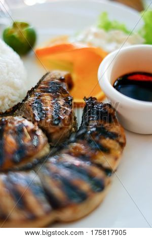 Delicious meal, grilled fish steak barbecue with rice and soy sauce