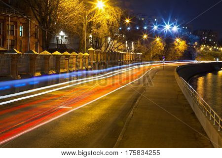 Urban city road with car light trails at night