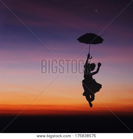Umbrella little girl jumping and sunset silhouette.
