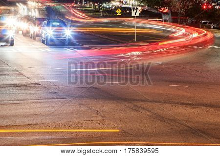 LAWRENCEVILLE, GA - NOVEMBER 2016: The headlights and brakelights from cars turning at a busy intersection motion blur and streak in Lawrenceville GA on November 23 2016.
