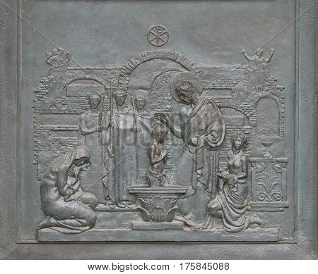 ROME, ITALY - SEPTEMBER 05: Bronze door with the image of the life of St. Peter: St Peter Baptizing in the Catacombs, basilica of Saint Paul Outside the Walls, Rome, Italy on September 05, 2016.