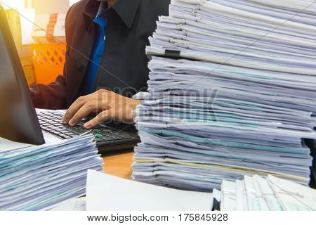 Documents On Desk Stack Up High Waiting To Be Managed