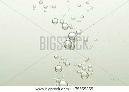 Beautiful fizz champagne bubbles flows toward the surface