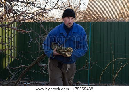 Man in working clothes working in the garden