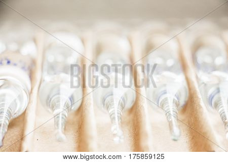 Row of transparent medical ampules in package. Close up
