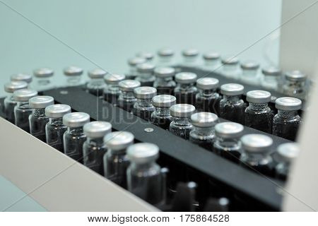 Sterile Capsules For Injection. Bottles On The Bottling Line Of The Pharmaceutical Plant. Machine Af