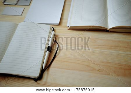 Blank stationery set on old wood background: business cards booklet notebook notepad and pen. Vintage style. Color