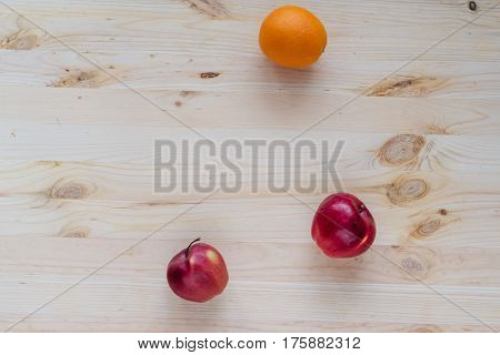 Fresh red and green apple, orange on wooden decks. Fruit, citrus table. Color