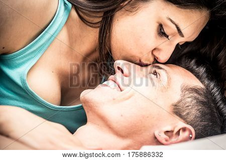 Couple kissing and having fun in bed
