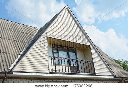 Gable and Valley type of roof construction. Building attic house construction with different types of roof designs and balcony.