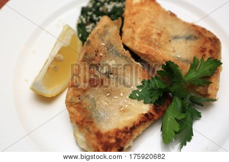 Pieces of breaded pikeperch on a plate