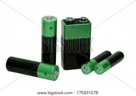 Many Different batteries green color, type AAA, type AA, type PP3, white background, isolated