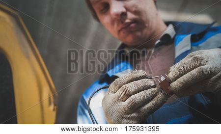 Work of automotive electrician - checking electro components in car, close up