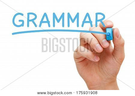 Hand writing Grammar with blue marker on transparent glass board.