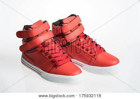 Fashion shoes with shoestring. Red sneaker and shoelace isolated on white background