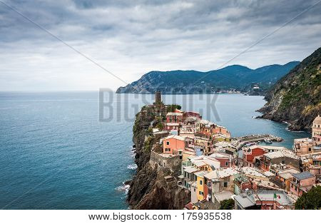 Old medieval watchtower and old houses on cliffs of  Vernazza town at Cinque Terre national park, Italy