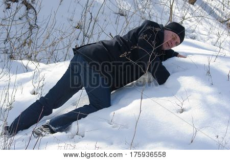 Brave professional zoologist is making a regular inspection of a brown bear hibernation.