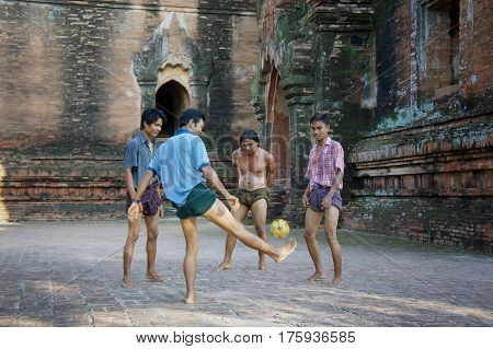 Myanmar Pagan - 06.11.2011: Locals play with kicking ball chinlon in the popular game sepak takraw