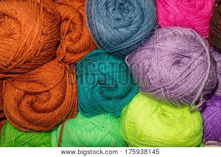 Many woolen yarn variegated colors, rainbow background