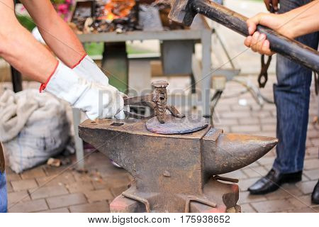 smith hand with big hammer and anvil