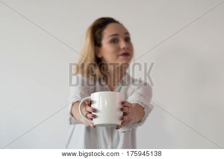 Woman drinking coffee in the morning at kitchen