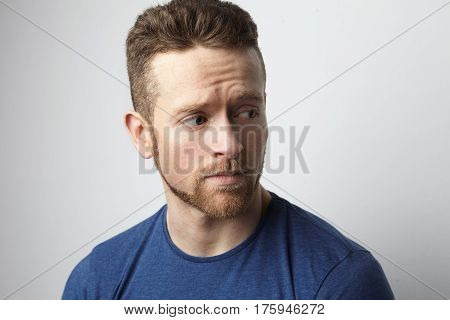 Closeup portrait of sad young man with worried stressed face expression. Obsessive compulsive, anxiety disorders.