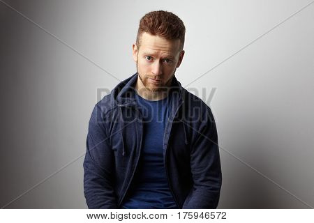 Closeup portrait of sad young man with worried stressed face expression. Obsessive compulsive, anxiety disorders.