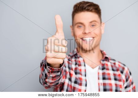 Handsome young man with beaming smile gesturing like