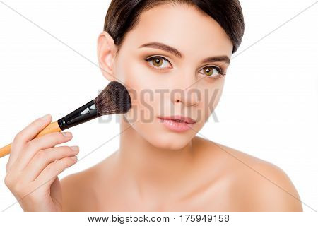 Sensual Young Woman On Isolated White Background  Applying Blusher On Her Cheekbones Using Make-up B