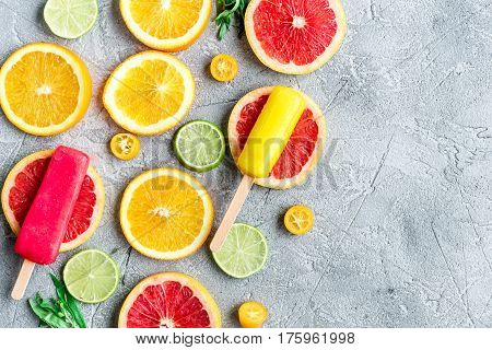 Homemade orange icecream with fresh fruits on stone table background top view mock-up