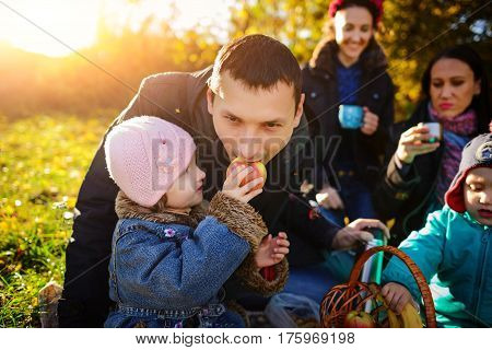 Girl Sitting On The Grass With An Apple In His Hand