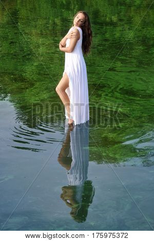 Girl in white dress on the water