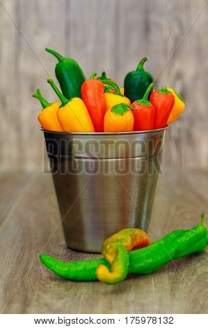 Assorted Peppers And Chilies In A Metal Bucket With Water Droplets Vertical Format