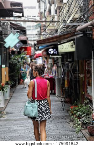 Chinese woman walking in Shanghai shopping street. Tourist on china travel at Tian Zi Fang area in the French concession.