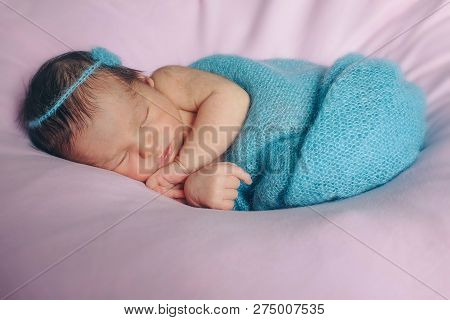 The Face Of A Schild With A Bandage On His Head Close-up
