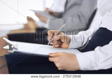 Business People Taking Part At Conference Or Training At Office, Close-up. Women Sitting On Chairs A