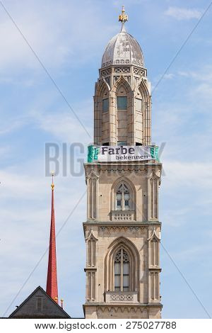 Zurich, Switzerland - May 25, 2016: One Of Two Towers Of The Grossmunster Cathedral Bearing A Banner