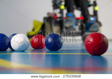 Boccia. A Disabled Man Sitting In A Wheelchair. Close Up Of Little Balls For Playing Boccia. Tricolo